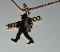 (A) Necklace chimney sweep with ladder in silver with a red ruby in the shape of a heart